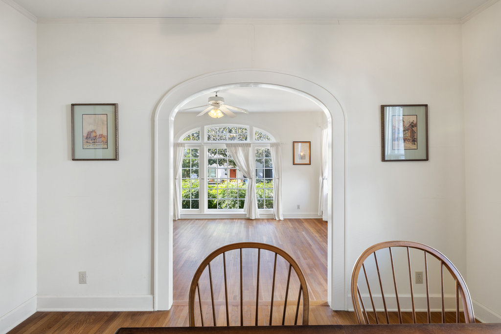1609 Wethersfield Road Austin, TX 78703 - Photo 4 of 38 Unfurnished dining area with wood finished floors, arched walkways, crown molding, and ceiling fan