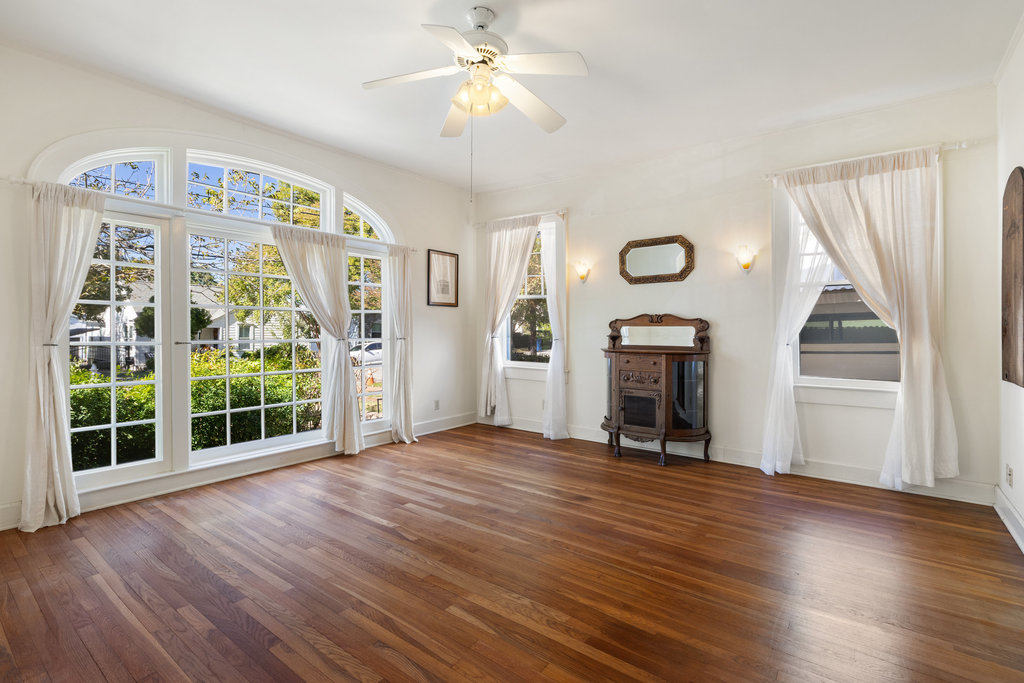 1609 Wethersfield Road Austin, TX 78703 - Photo 5 of 38 Unfurnished living room featuring wood-type flooring, plenty of natural light, and ceiling fan