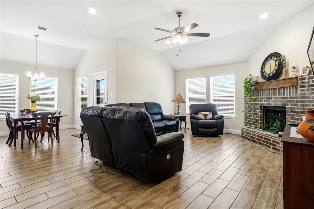 904 Avagail Avenue Springtown, TX 76082 - Photo 16 of 27 a living room with furniture a fireplace and a large window