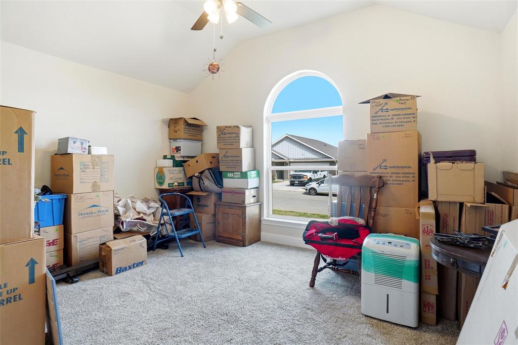 904 Avagail Avenue Springtown, TX 76082 - Photo 24 of 27 a living room with furniture and a flat screen tv