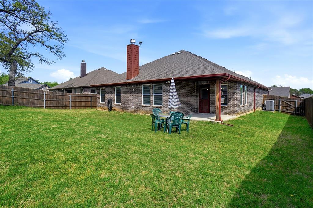 904 Avagail Avenue Springtown, TX 76082 - Photo 26 of 27 a front view of a house with garden