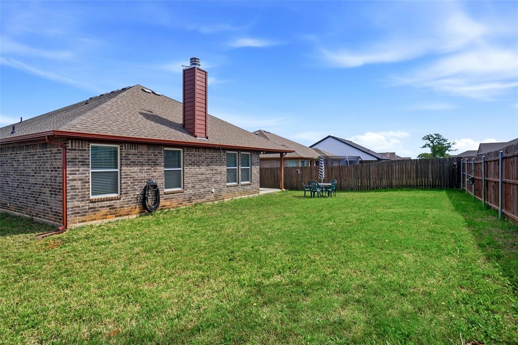 904 Avagail Avenue Springtown, TX 76082 - Photo 27 of 27 a front view of a house with garden