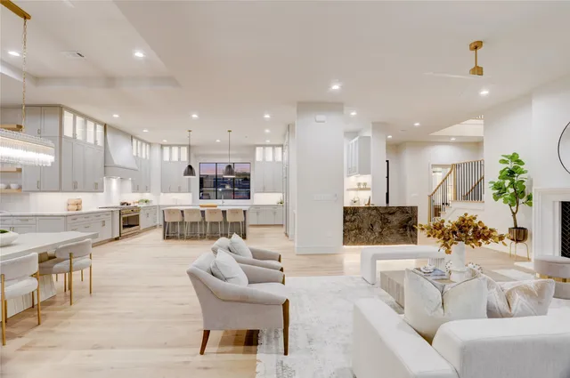 a living room with furniture and a view of kitchen