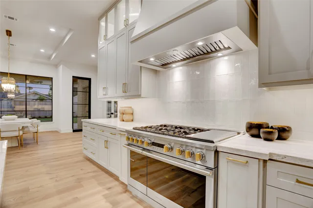 a kitchen with granite countertop a stove and a sink