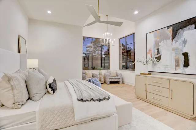 a spacious bedroom with a large bed and a window