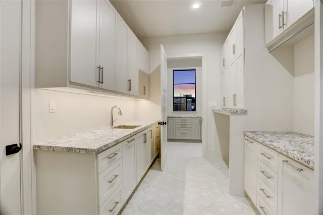 a kitchen with granite countertop cabinets and sink