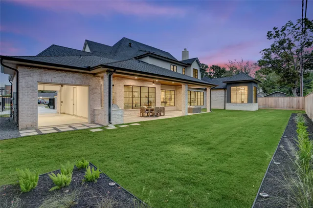 a front view of a house with a garden and yard