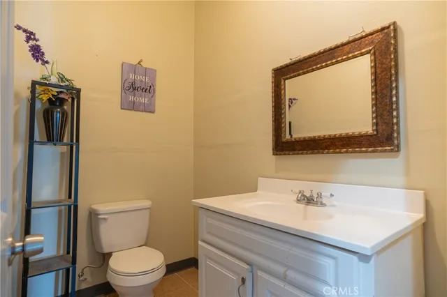a bathroom with a sink and mirror with toilet
