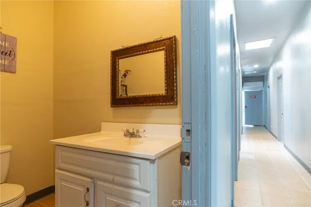 a view of a workspace with furniture and wooden floor