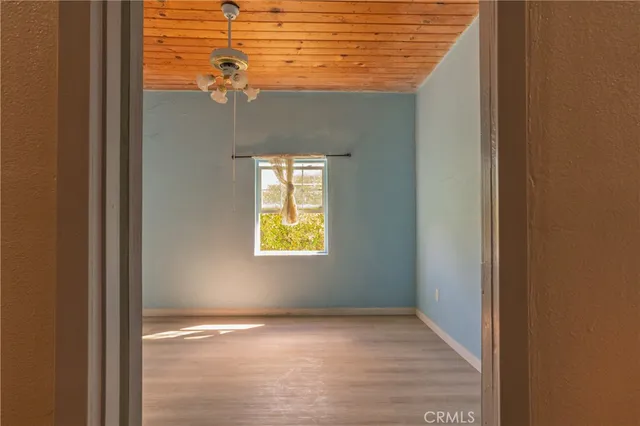 a view of a room with furniture and wooden floor
