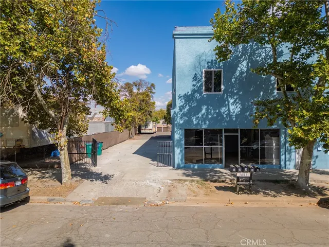an aerial view of a house with a yard and lake view