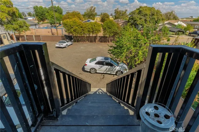 an aerial view of a city with lots of residential buildings and ocean view in back