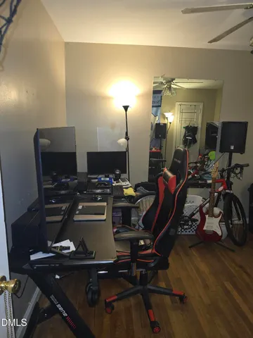 a view of a workspace with furniture and gym equipment