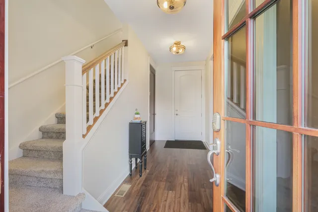 a view of entryway with wooden floor and stairs