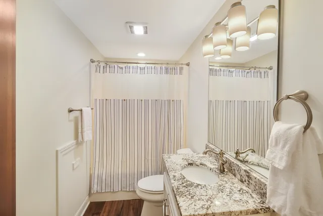 a bathroom with a sink toilet and shower