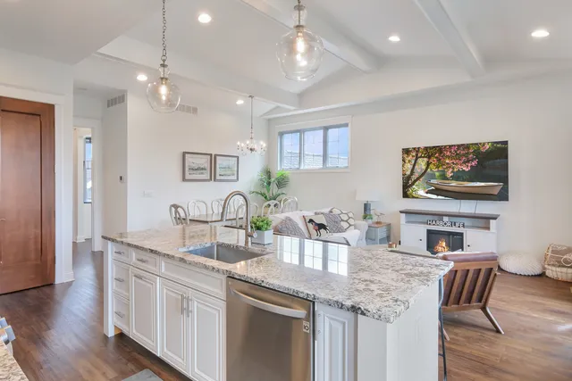 a kitchen with stainless steel appliances granite countertop a sink and a microwave