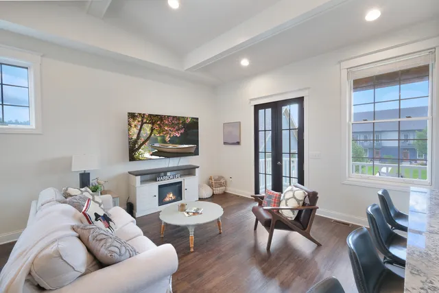 a living room with furniture a window and a flat screen tv