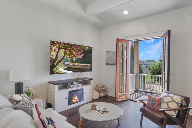 a living room with furniture a fireplace and a flat screen tv