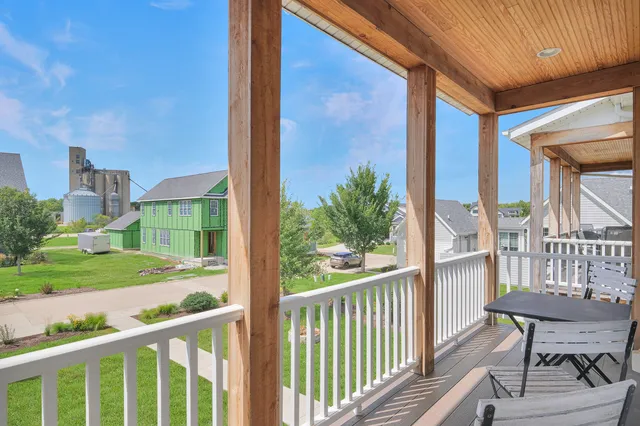 a view of a porch with a table and chairs