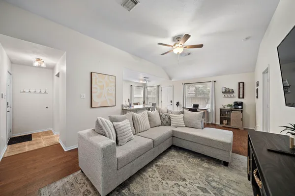 a living room with furniture and a chandelier