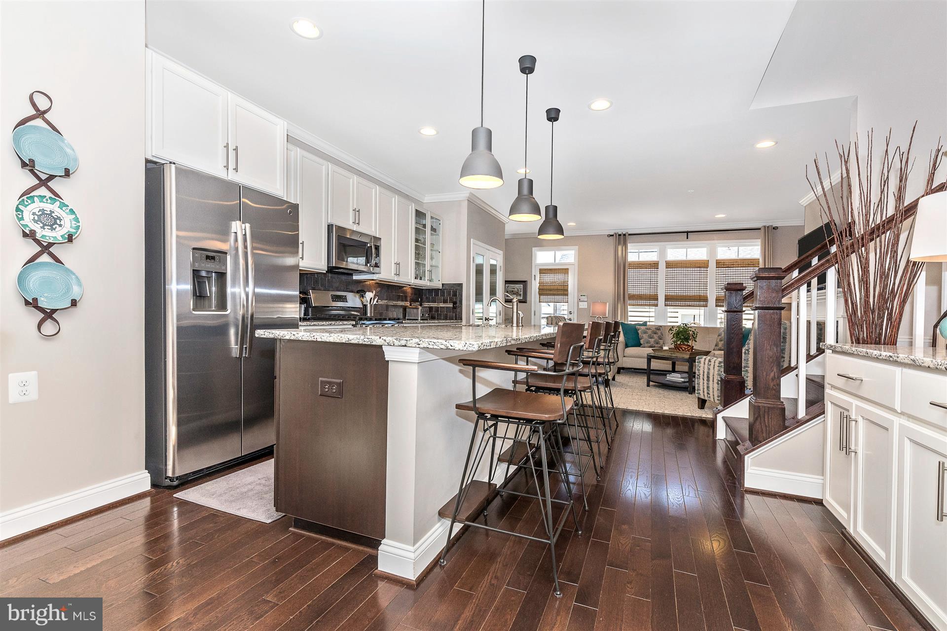 1149 Holden Road Frederick, MD 21701 - Photo 7 of 28 a kitchen with stainless steel appliances a dining table chairs stove refrigerator and cabinets