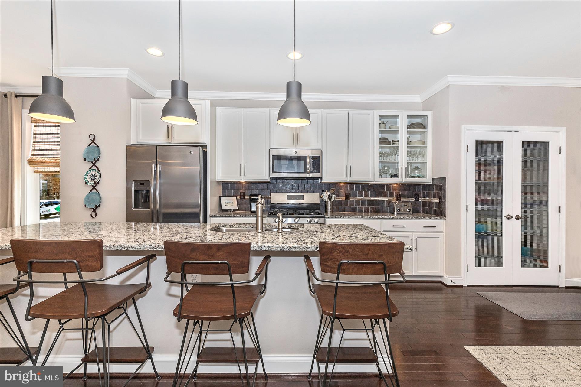 1149 Holden Road Frederick, MD 21701 - Photo 8 of 28 a kitchen with a table chairs refrigerator and cabinets