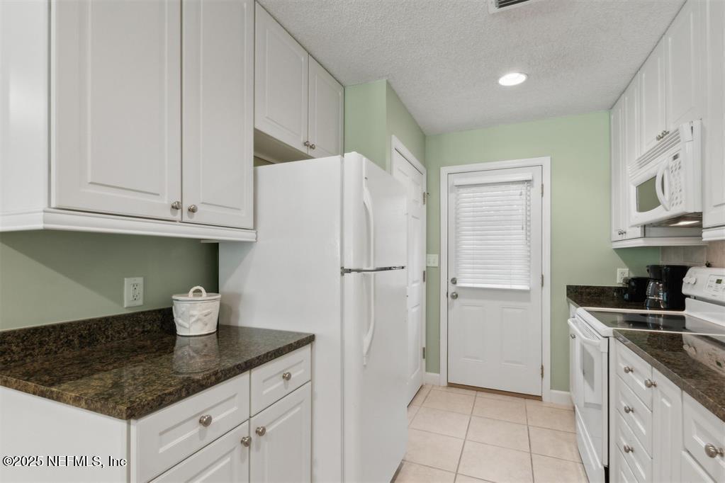 3328 Sea Marsh Road Fernandina Beach, FL 32034 - Photo 17 of 44 a kitchen with stainless steel appliances granite countertop a refrigerator and a sink