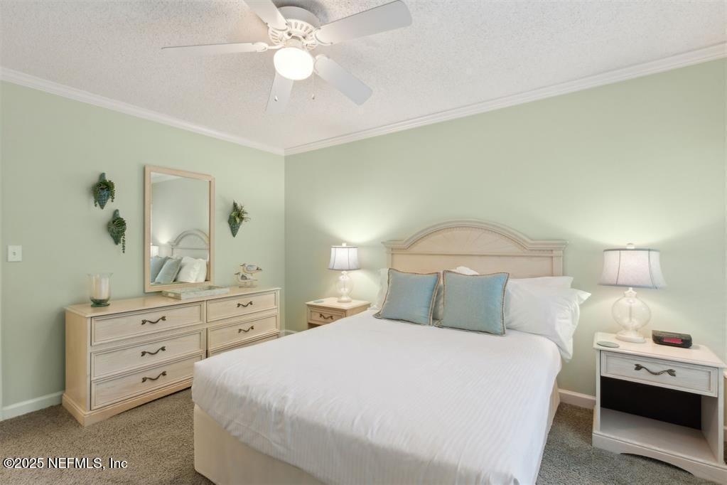 3328 Sea Marsh Road Fernandina Beach, FL 32034 - Photo 21 of 44 a bedroom with a bed and a dresser