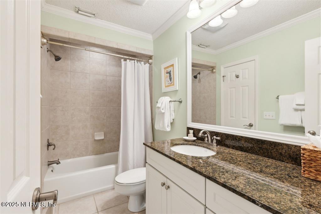 3328 Sea Marsh Road Fernandina Beach, FL 32034 - Photo 22 of 44 a bathroom with a granite countertop sink a toilet a mirror a bathtub and shower