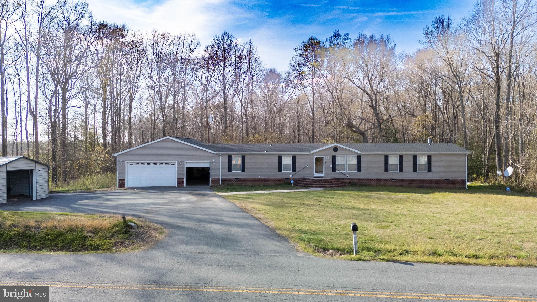 8791 Menokin Road Montross, VA 22520 - Photo 2 of 37 a front view of a house with yard swimming pool and outdoor seating