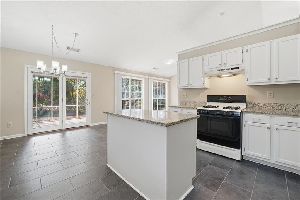 3070 Bugle Drive Duluth, GA 30096 - Photo 15 of 43 a kitchen with granite countertop white cabinets and appliances