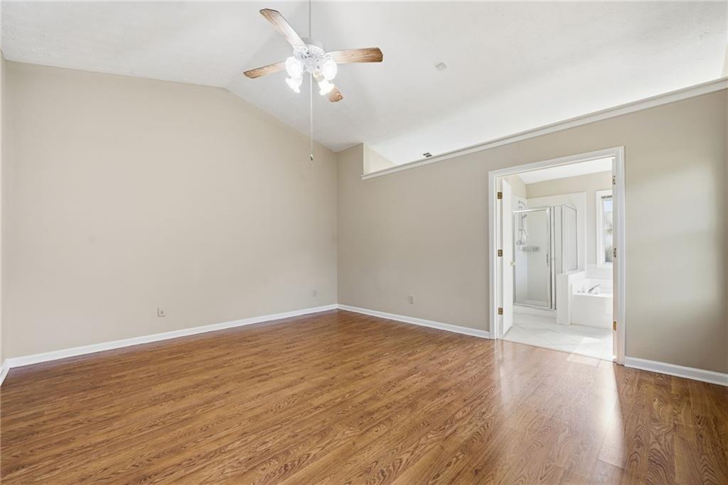 3070 Bugle Drive Duluth, GA 30096 - Photo 19 of 43 an empty room with wooden floor and ceiling fan