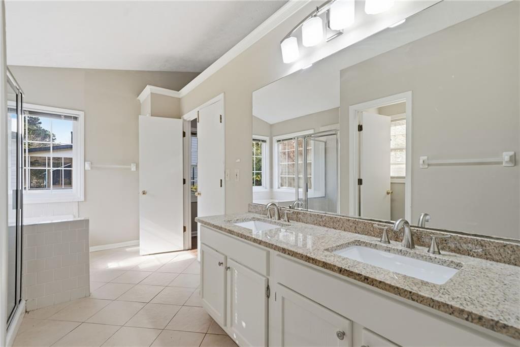 3070 Bugle Drive Duluth, GA 30096 - Photo 21 of 43 a bathroom with a granite countertop sink and a mirror
