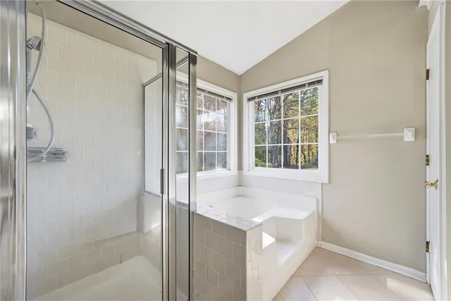 a bathroom with a bathtub and a shower