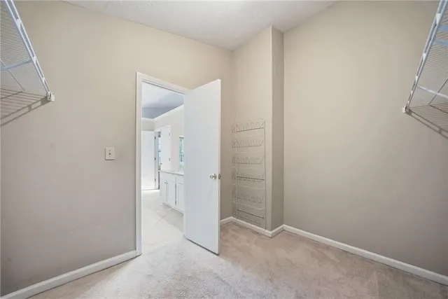 an empty room with a bench and mirror