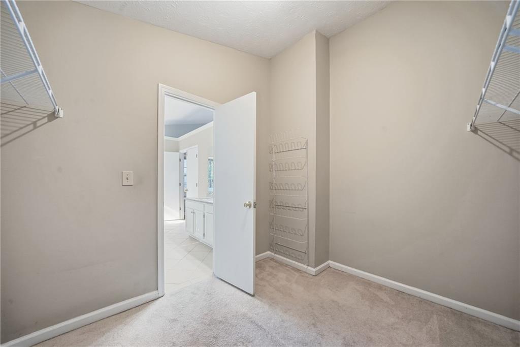 3070 Bugle Drive Duluth, GA 30096 - Photo 25 of 43 an empty room with a bench and mirror