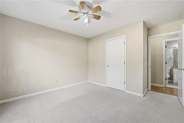 an empty room with chandelier fan