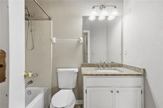 a bathroom with a sink vanity mirror and toilet