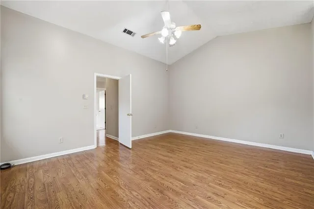 a view of an empty room with wooden floor