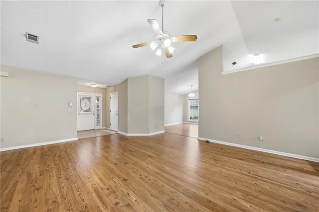 wooden floor in an empty room with a window