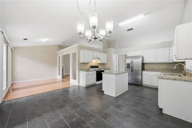 a view of a kitchen with a sink stainless steel appliances and cabinets