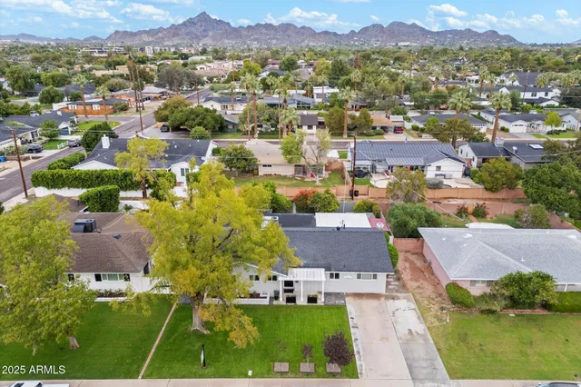 an aerial view of residential houses with outdoor space