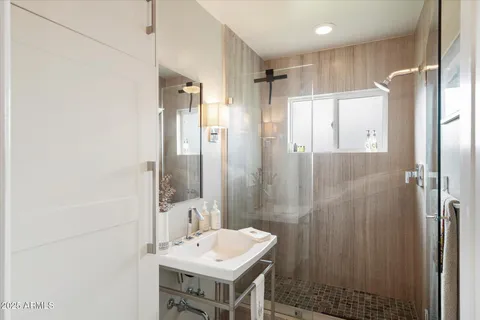 a kitchen with a stove a refrigerator a sink and chairs