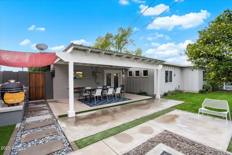 a table and chairs in patio of a house
