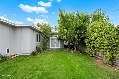 a view of a house with a yard and sitting area