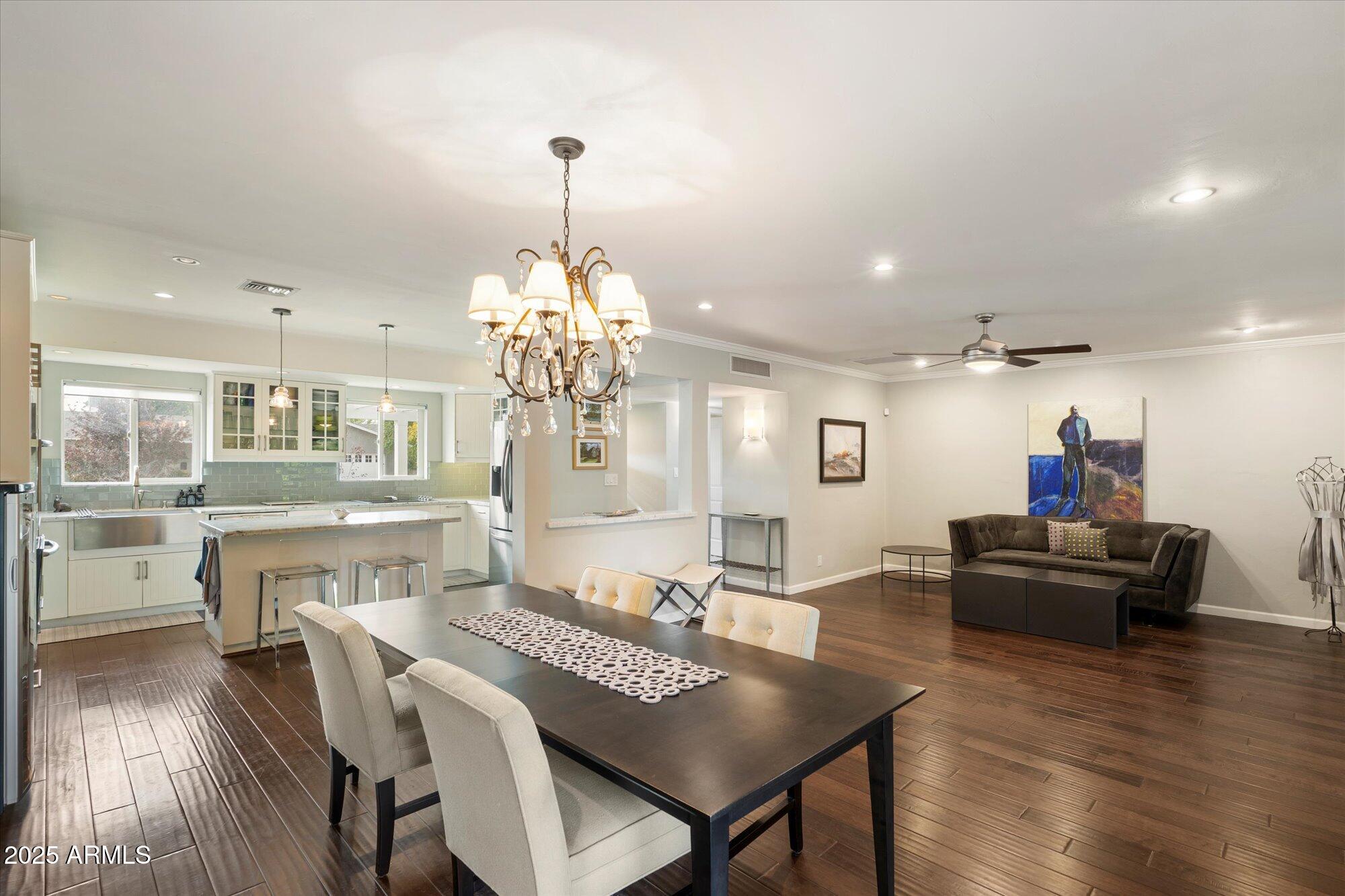 3328 East Turney Avenue Phoenix, AZ 85018 - Photo 8 of 35 a view of a dining room with furniture wooden floor and chandelier
