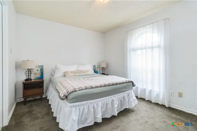 a bedroom with a bed and window