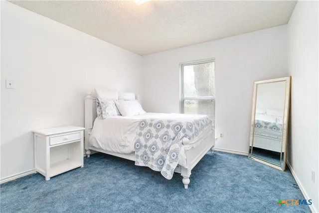 a bedroom with a bed and a cabinets