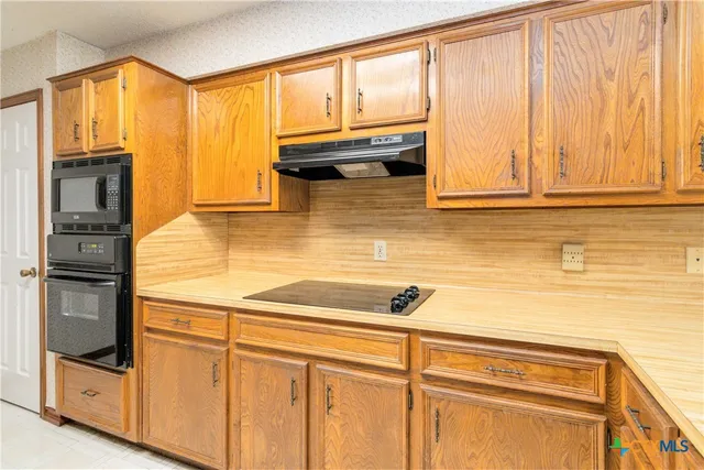 a kitchen with a window and refrigerator