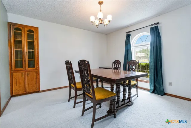 a dining room with furniture and window